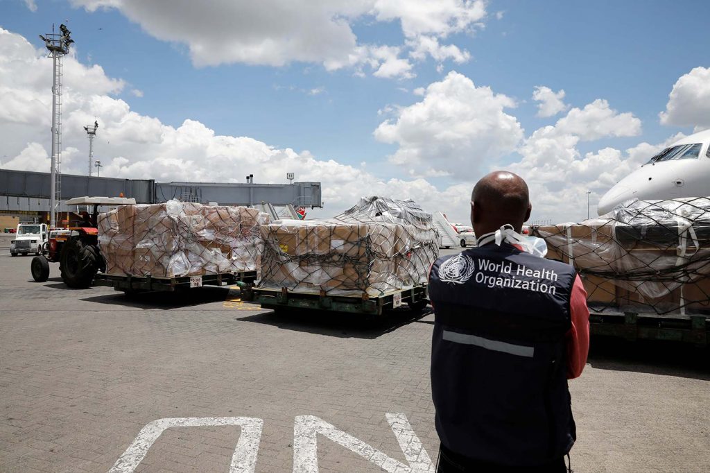 A World Health Organization worker watches as a shipment of medical supplies donated to Africa by Chinese billionaire Jack Ma and the Alibaba Foundation to fight the coronavirus disease from arrives at Jomo Kenyatta International Airport in Nairobi, Kenya on March 24, 2020.