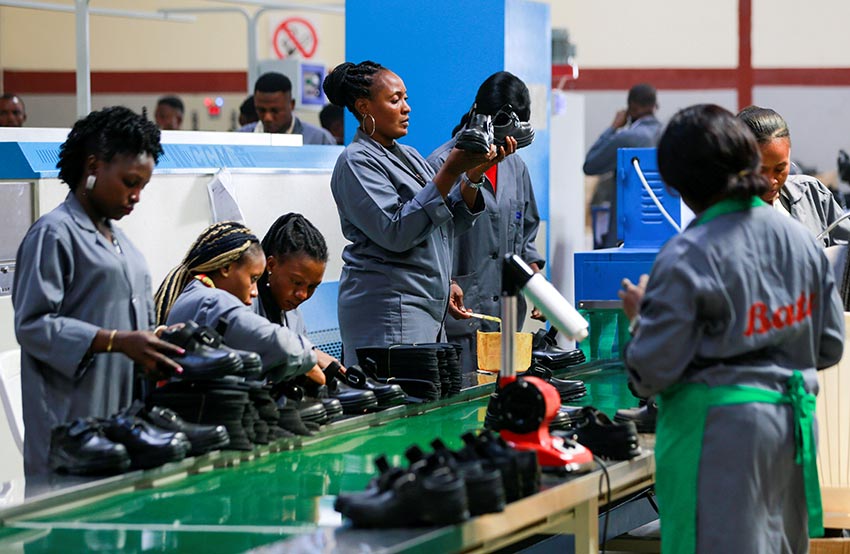 Women workers inspect shoes at a Bata shoe factory in Abuja