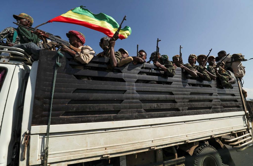 Members of Amhara region militias ride on their truck as they head to face the Tigray People's Liberation Front (TPLF), in Sanja, Amhara region near a border with Tigray, Ethiopia on November 9, 2020.