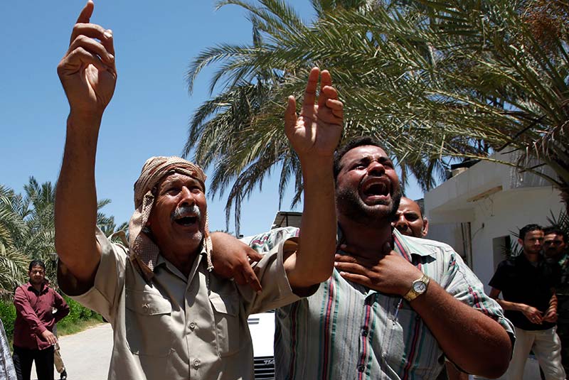 Libyans mourn people who were killed by the NATO air strikes in Surman in June 2011.