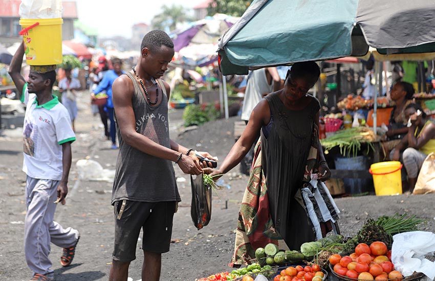 A Congolese man buying groceries at an open-air market in Kinshasa in March 2020, as concerns about the spread of COVID-19 escalated. The Democratic Republic of Congo got so few testing kits that they had to be rationed.