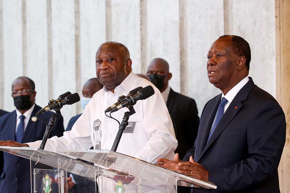 Cote d’Ivoire President Alassane Ouattara, left, speaks at a news conference, next to former President Laurent Gbagbo, on July 27 at the presidential palace in Abidjan.