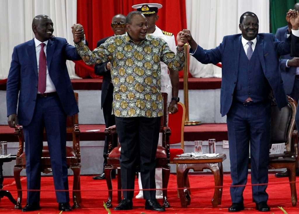 Kenyan President Uhuru Kenyatta, center, holds hands with Deputy President William Ruto, left, and opposition leader Raila Odinga, right, in Nairobi during the launch of the Building Bridges Initiative, a government program intended to address election violence, in November 2019. Ruto’s allies fear that Kenyatta’s rapprochement with Odinga portends that he’s going to renege on his support for the deputy president to succeed him in 2022.