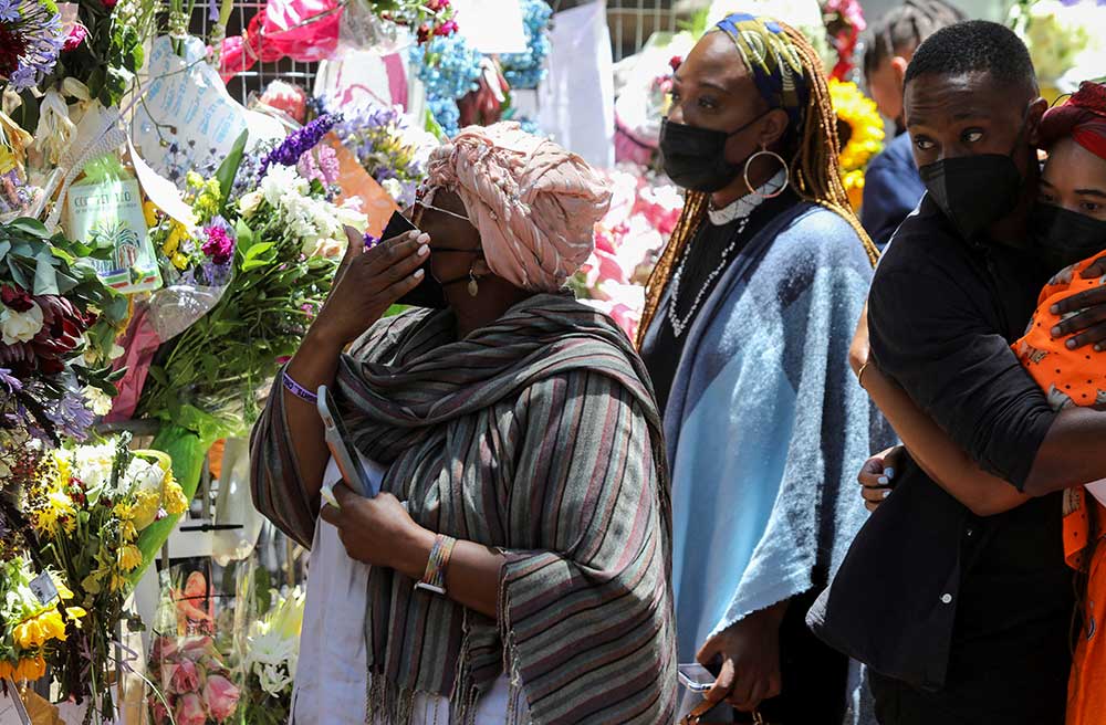 Members of Archbishop Tutu’s family view messages from the public on the remembrance wall outside St. Georges Cathedral in Cape Town, on December 31.