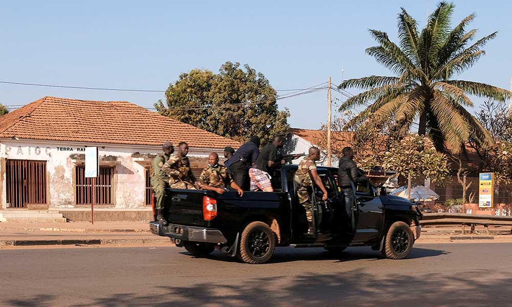 Armed soldiers move on the main artery of the capital after heavy gunfire around the presidential palace in Bissau, Guinea Bissau on February 1, 2022.