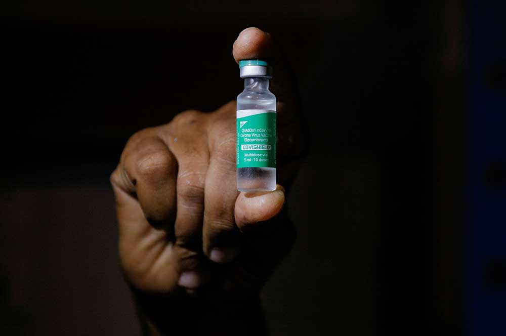 A man displays a vial of AstraZeneca’s COVISHIELD vaccine in Accra, Ghana in February.
