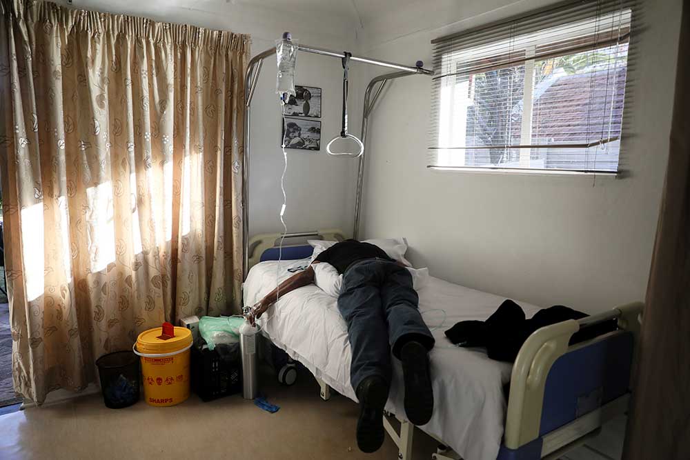 A patient lies on a hospital bed in a ward during the COVID-19 outbreak in Johannesburg, South Africa in early July.