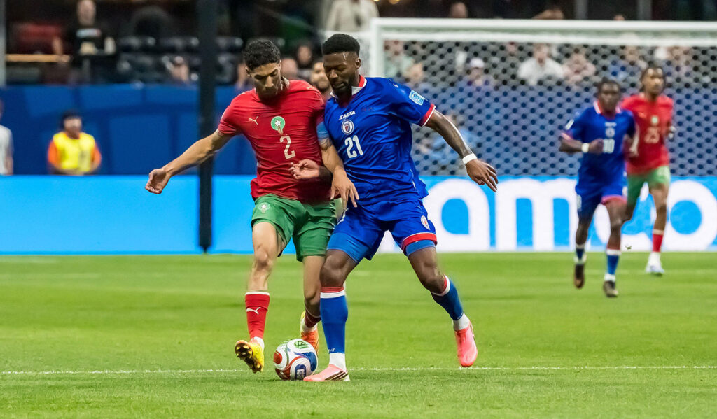 Star Moroccan defender Achraf Hakimi, left, tries to take the ball from Haiti forward Josue Casimir during their Group C match in Atlanta, Georgia on June 24. Morocco won 4-2, with two late goals breaking a hard-fought tie.
