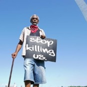 A man holds a sign under the St. Louis Arch during a protest against the death in Minneapolis police custody of George Floyd, in St Louis, Missouri on June 14, 2020. A man holds a sign under the St. Louis Arch during a protest against the death in Minneapolis police custody of George Floyd, in St Louis, Missouri on June 14, 2020.