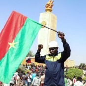 A man in Ouagadougou holds a Burkinabe flag to show support for the military government on January 25. A man in Ouagadougou holds a Burkinabe flag to show support for the military government on January 25.