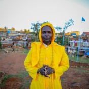 Steven Ouma praying at a Legio Maria (Legion of Mary) outdoor worship ground. The church, founded in 1963, is a syncretic charismatic Kenyan sect derived from Catholicism.