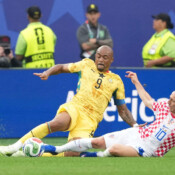 Croatian midfielder Luka Modric, right, tackles Ghanaian captain Jordan Ayew during their Group L match in Philadelphia, Pennsylvania, on June 27. Croatia won 2-1 on a late goal by Nikola Vlasic, but both teams advanced to the first knockout round. Modric, 40, became the oldest player to get an assist in World Cup history on that goal. Croatian midfielder Luka Modric, right, tackles Ghanaian captain Jordan Ayew during their Group L match in Philadelphia, Pennsylvania, on June 27. Croatia won 2-1 on a late goal by Nikola Vlasic, but both teams advanced to the first knockout round. Modric, 40, became the oldest player to get an assist in World Cup history on that goal.